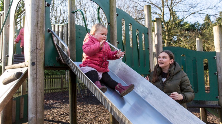 Visitors playing in the gated play area at Speke Hall, Liverpool